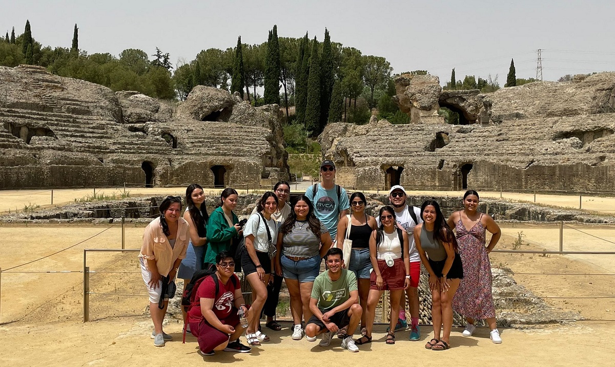 students posing in front of ruins